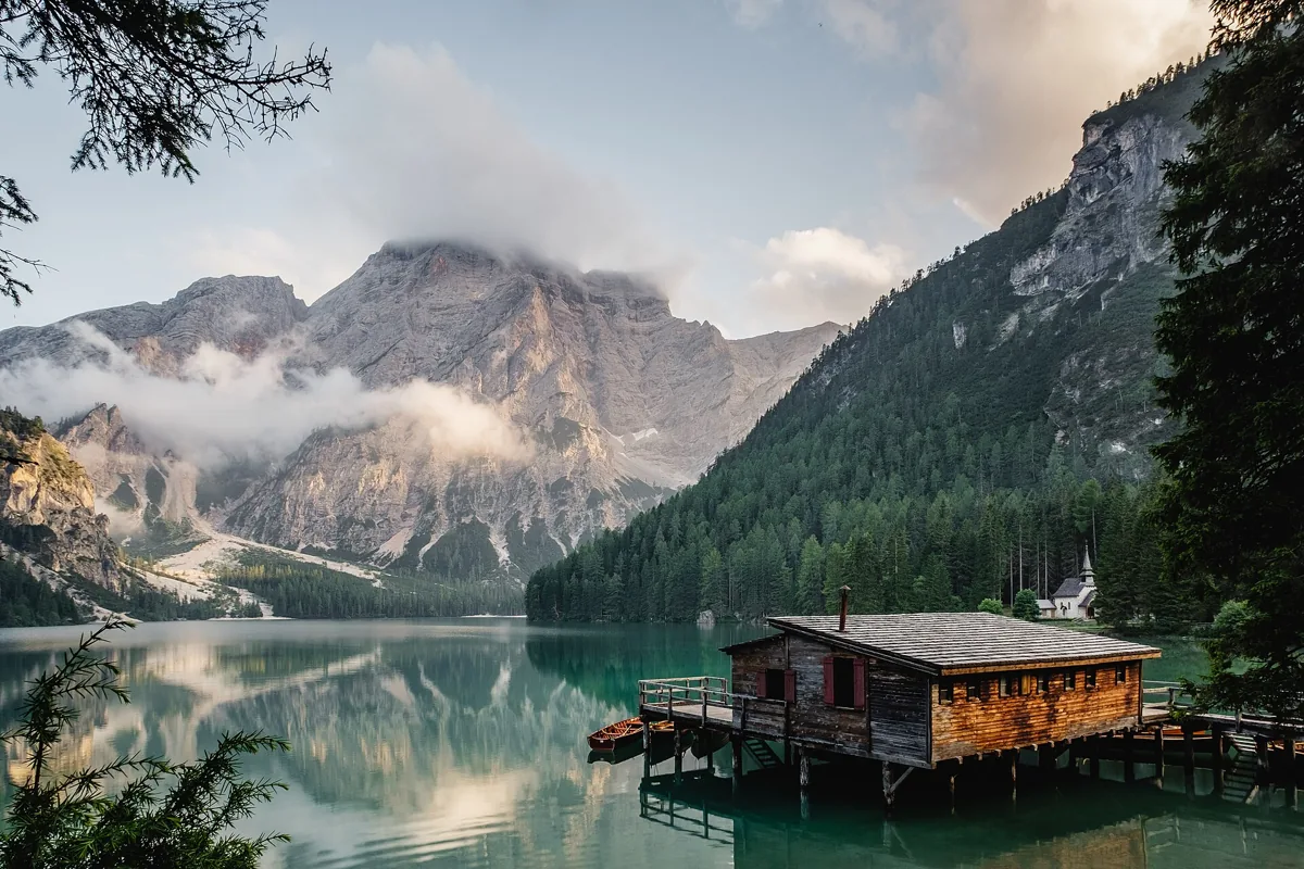 The wooden boathouse and turquoise water of Lake Braies in the Dolomites